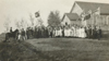 School photograph, students and parents, union jack flag, flags, dresses and suits, special occasion , circa 1914-1921province of Saskatchewan, Canada  